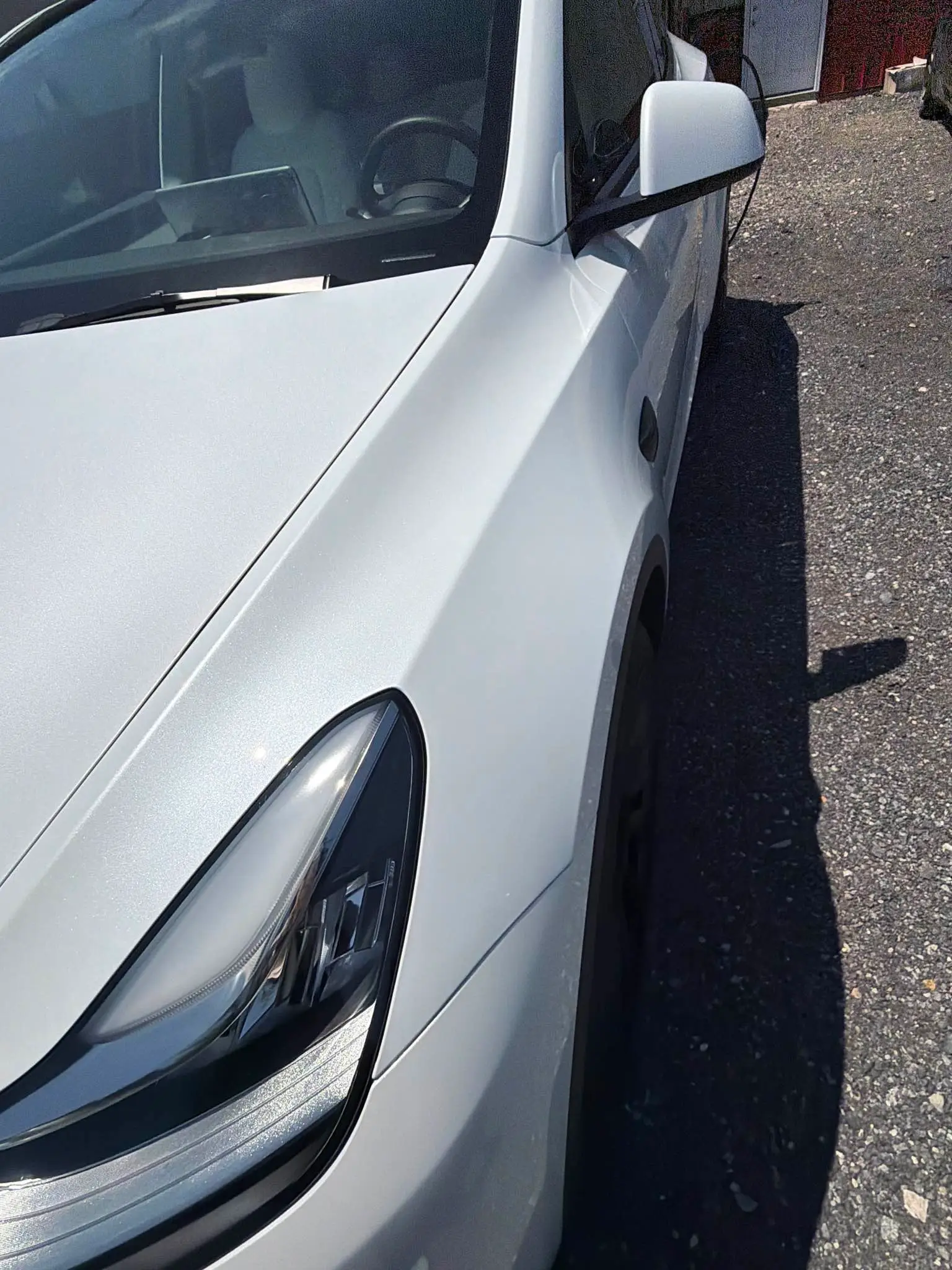 White Tesla after repair, front fender straightened and refinished