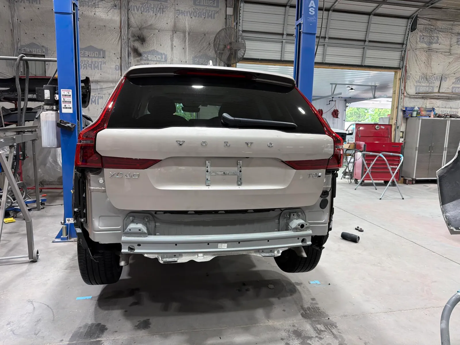 Volvo SUV on a lift in the Eastern Auto Works shop with the rear bumper cover removed